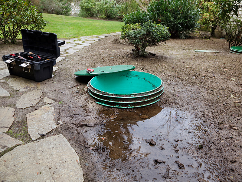 Septic tank access point opened and overflowing