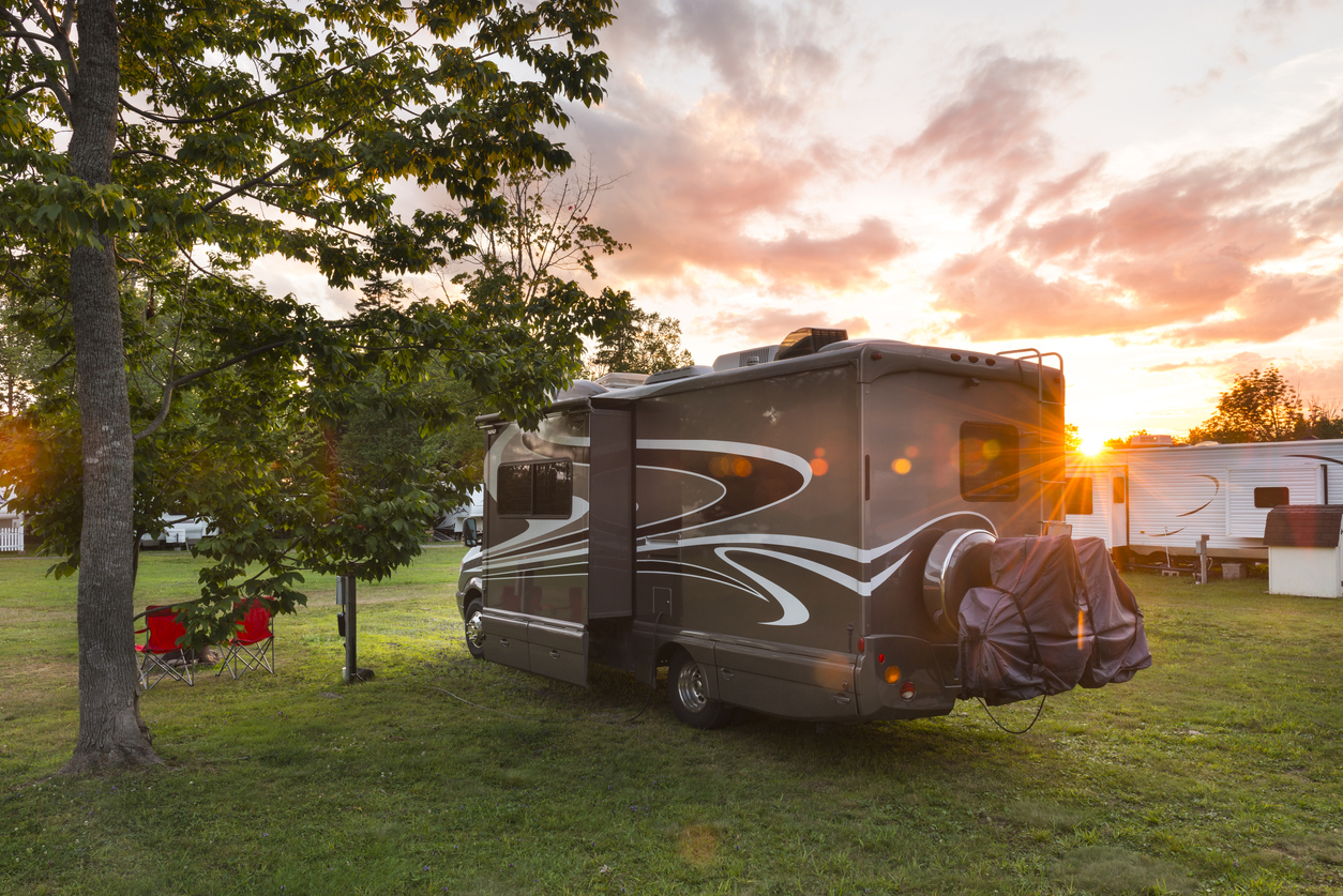 Road trip in motor home. North America. Motor home, camping at sunset. Lens flare.