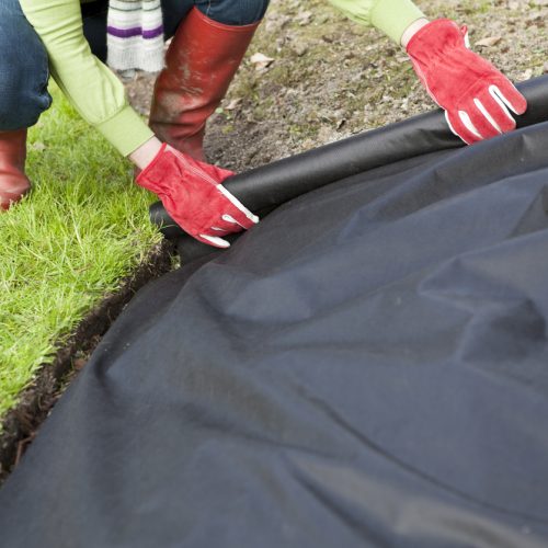 Landscaping Fabric being installed in garden